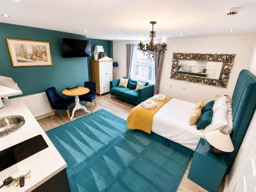 a hotel room with a bed and a bathroom at Market View 1 in Hexham