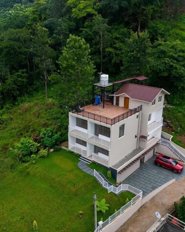 an aerial view of a house with a yard at River Side Paradise By Greenleaves Munnar in Anachal