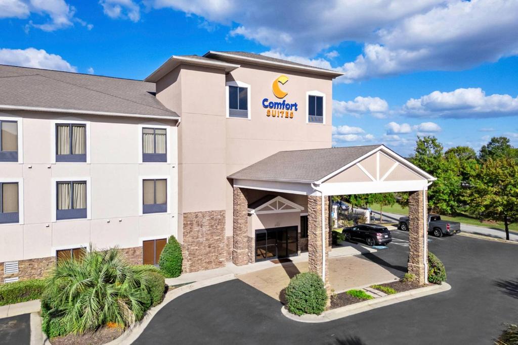 a front view of a hotel with a car parking lot at Comfort Suites Augusta Riverwatch in Augusta