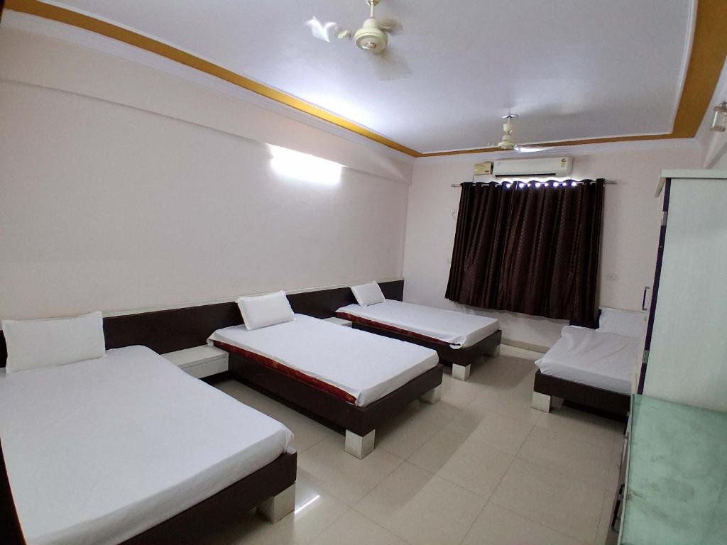 a hospital room with two beds and a window at The JANAKPURI in Ajmer