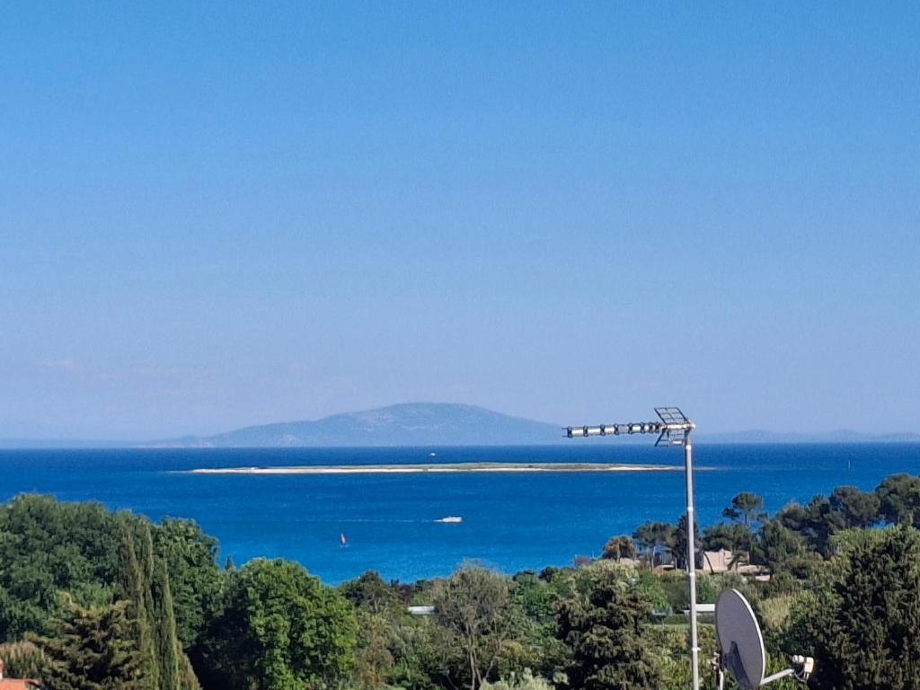 a view of the ocean with a street light at Apartman Premantura Rumora in Premantura