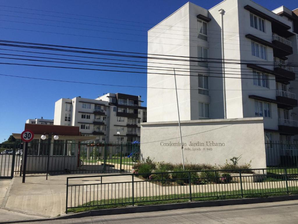 a building with a sign in front of it at Departamento Jardin Urbano 3D y 2B-Valdivia in Valdivia