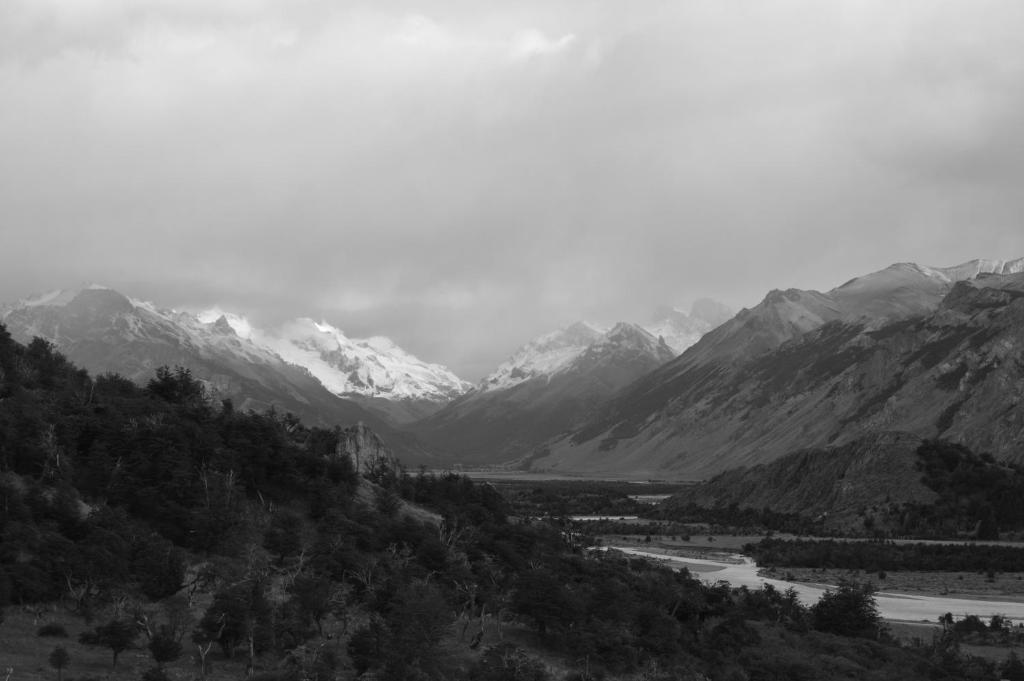 una foto en blanco y negro de un valle con montañas en Confin Patagonico en El Chaltén