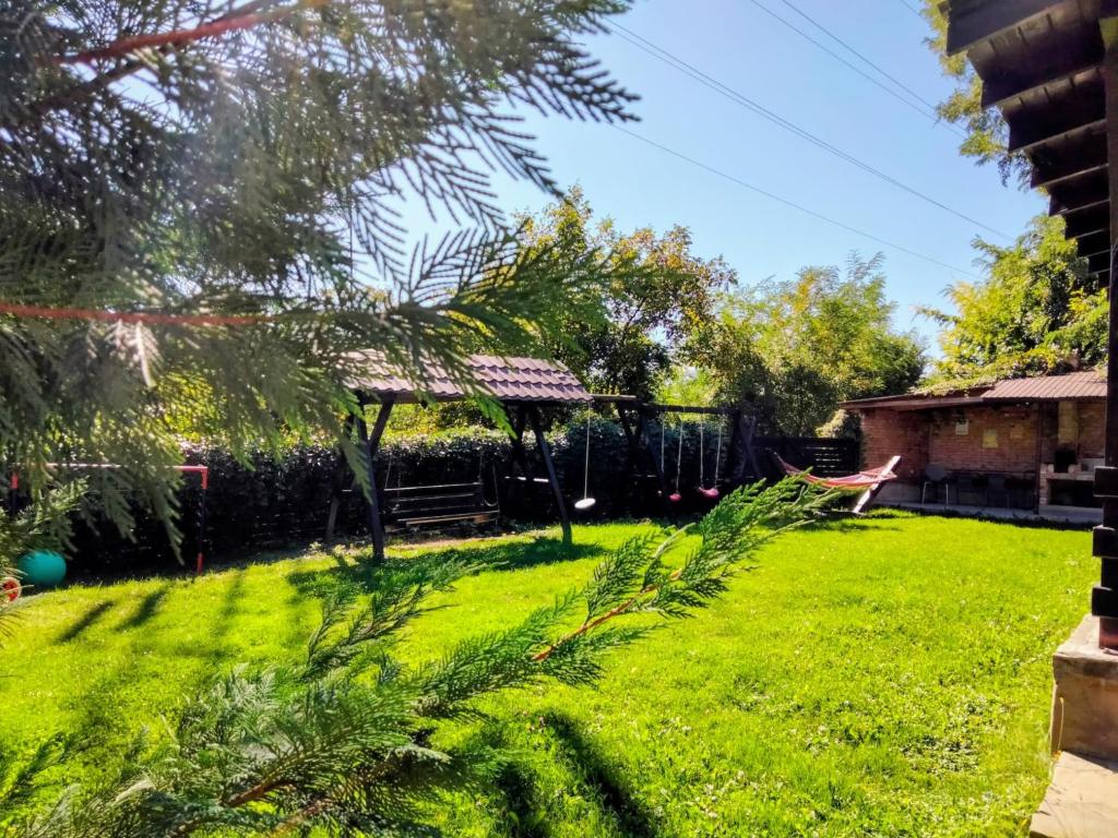 a backyard with a gazebo and a grass yard at Casa Roxana in Pangarati