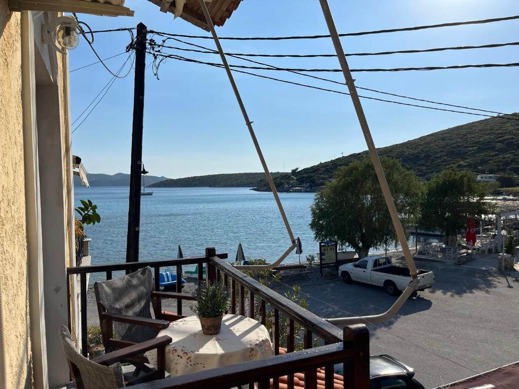 a balcony with a table and a view of the water at Poseidonio Apartments in Poseidónion