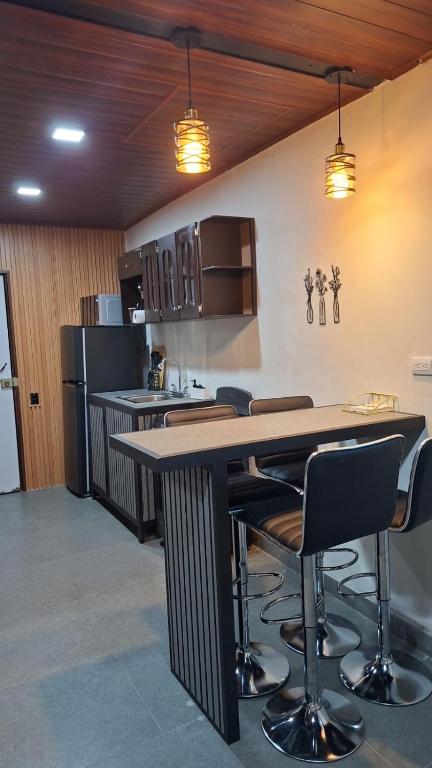 a kitchen with a table and chairs in a room at Apartamentos Javi in Tela