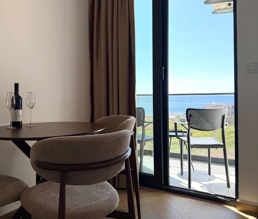 a room with a table and chairs and a balcony at Maresa 8 in Čanj