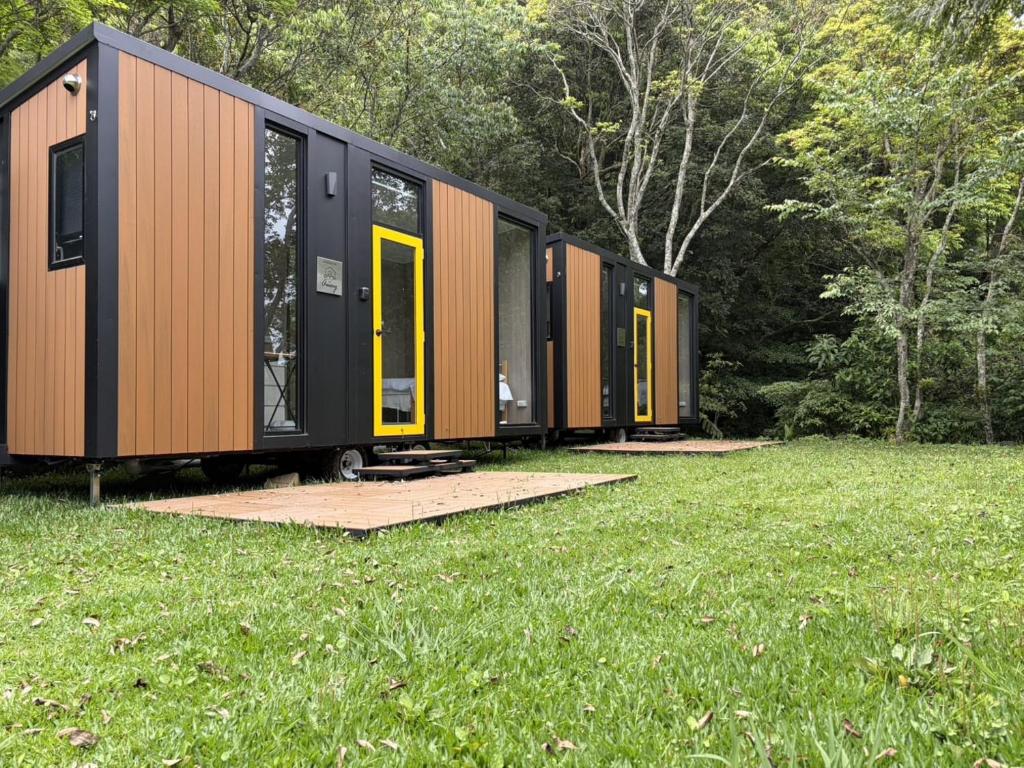 a row of modular homes in a field of grass at Mountain Calm Inns in Xiayun