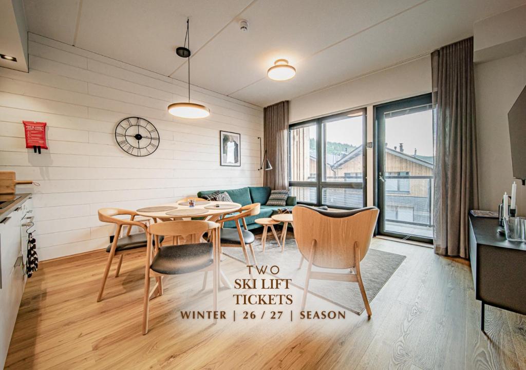 a kitchen and living room with a table and chairs at Ski Chalet C8 Levi Center incl 2 ski passes by Aavalevi in Levi