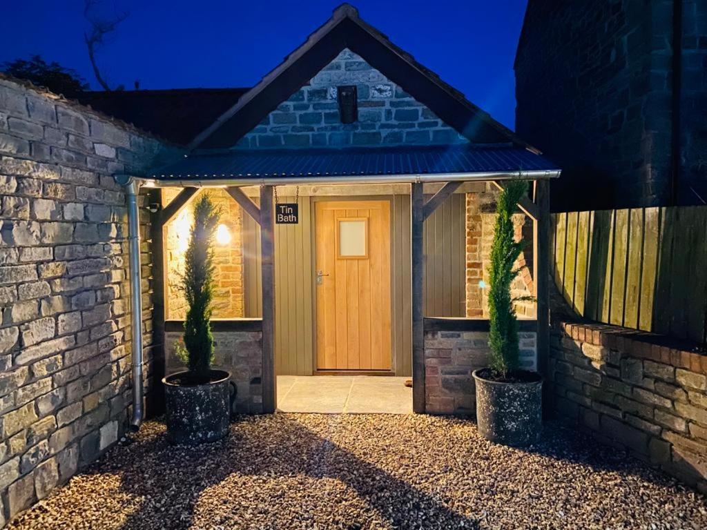 a front door of a house at night at Tin Bath As Glorious as its Namesake in Aller
