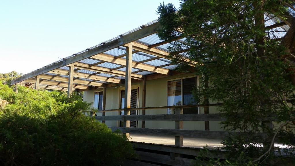 a house with a pergola on the side of it at Bushland Retreat in Cape Bridgewater