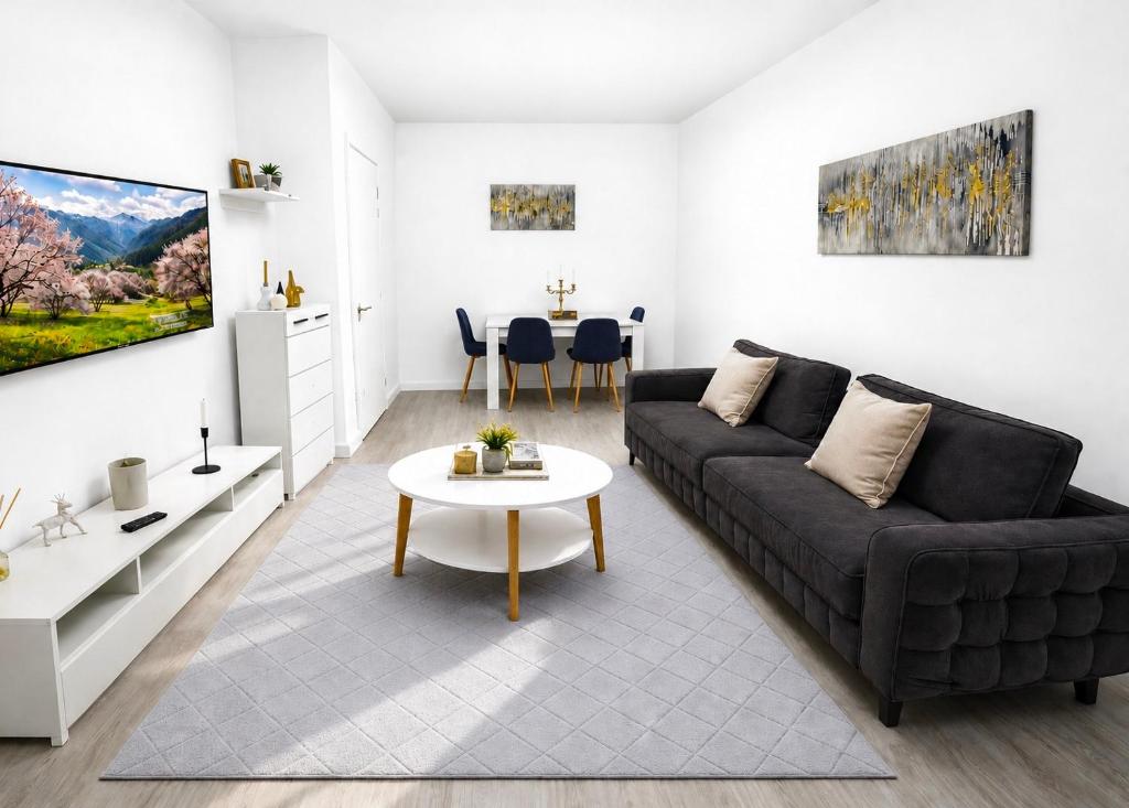 a living room with a couch and a table at A B V Central Apartment- Unitate autorizata de Ministerul Turismului in Râmnicu Vâlcea