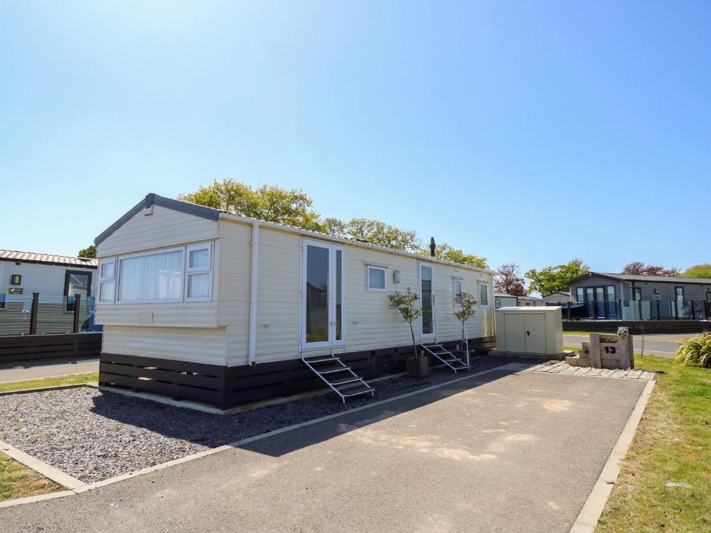 a tiny house parked in a parking lot at MillRythe Holiday Park Dunlin Walk 13 in North Hayling
