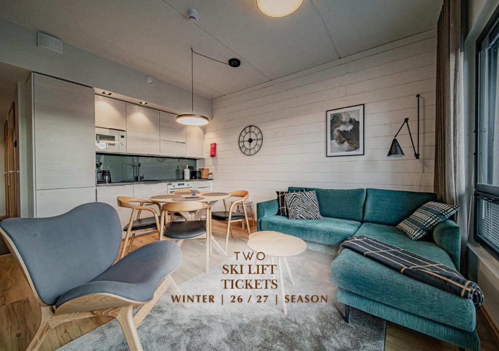 a living room with a green couch and a table at Ski Chalet C10 Levi Center incl 2 ski passes by Aavalevi in Levi