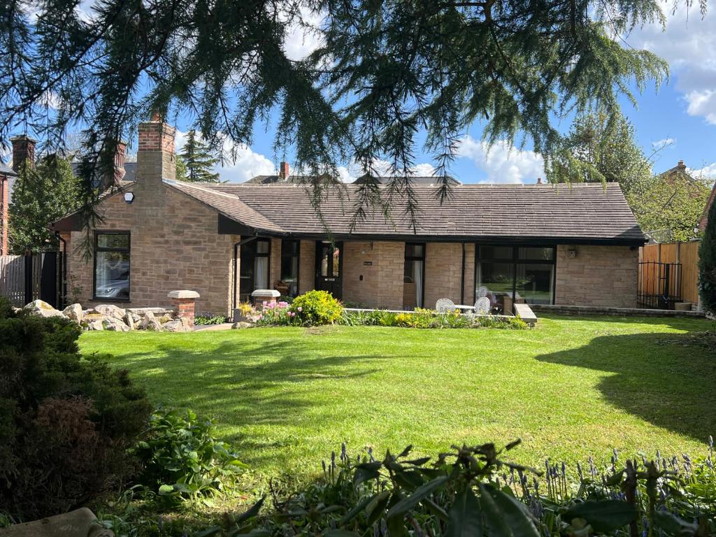 a brick house with a lawn in front of it at Havendale in Chesterfield