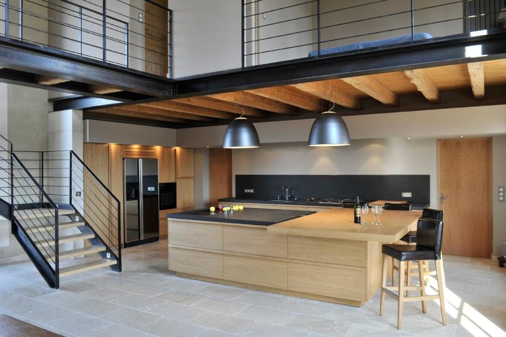 a kitchen with a large island in a room at A charming Provençal farmhouse in Mouriès
