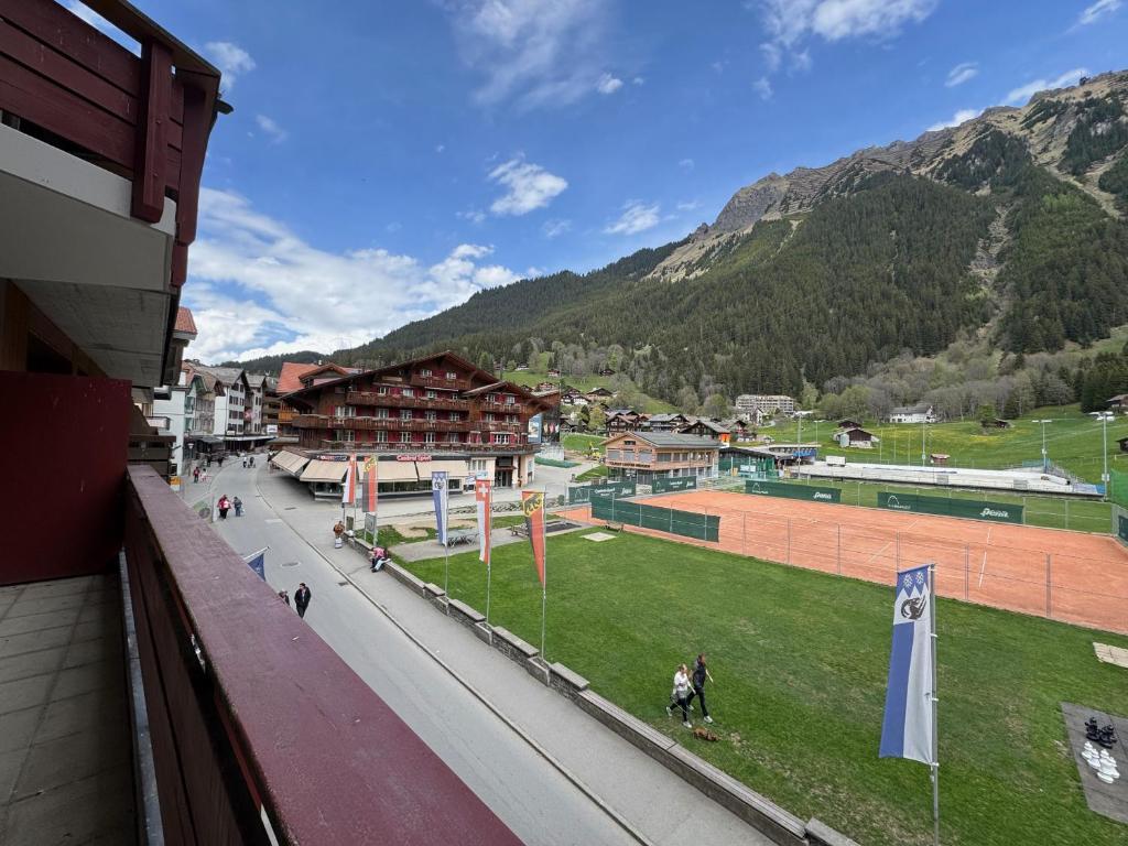 a view of a city with mountains in the background at Eiger Residence 1 in Wengen