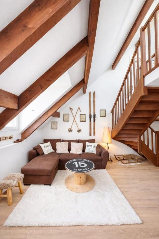 a living room with a couch and a table at Le chalet Mountain-style duplex 6 people in Meulan