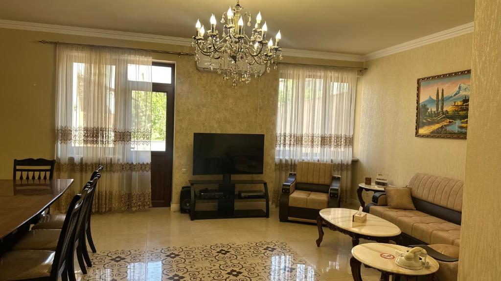 a living room with a couch and a television at Nice villa in Yerevan