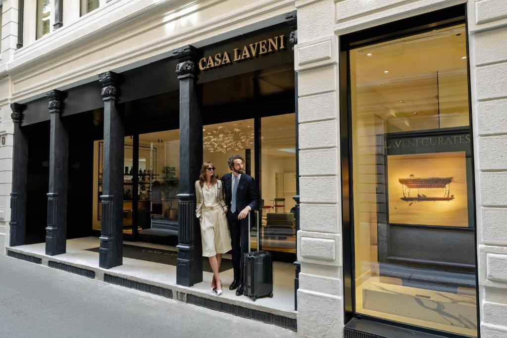 a man and a woman standing in a store window at Casa Laveni in Milan