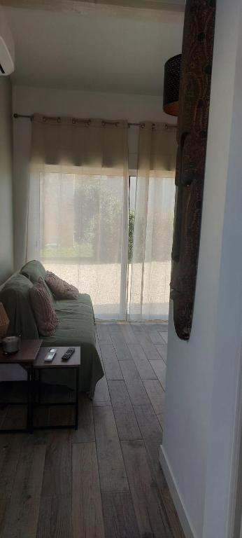 a bedroom with a bed and a table and a window at studio chez amandine in Pernes-les-Fontaines