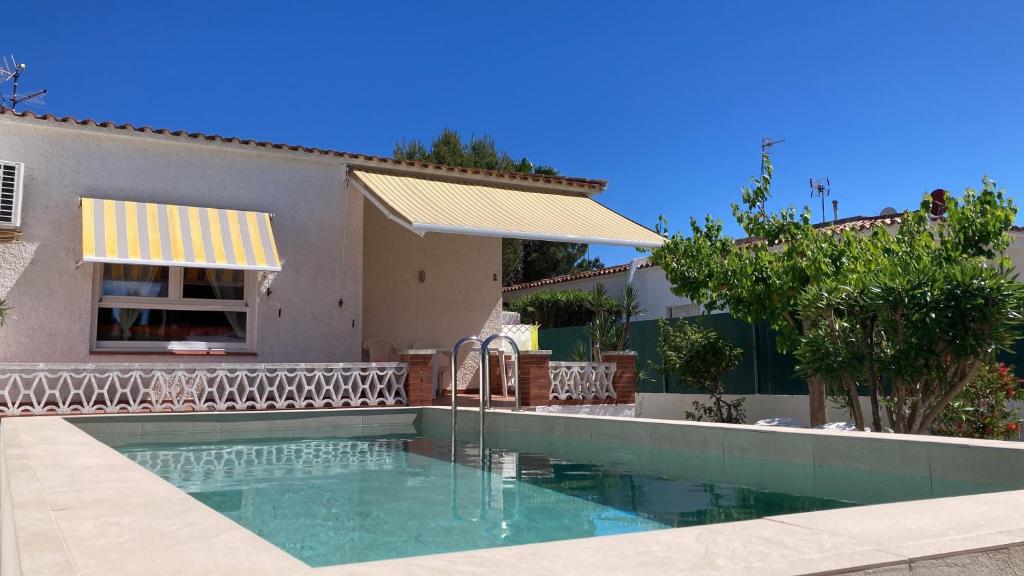 a swimming pool in front of a house at Casa Gonia in Riumar