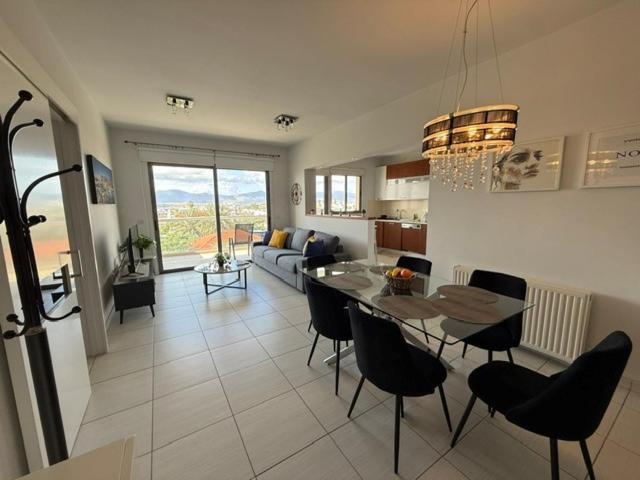 a kitchen and living room with a table and chairs at Queens Boutique Apartment 2BR in Ayios Dhometios