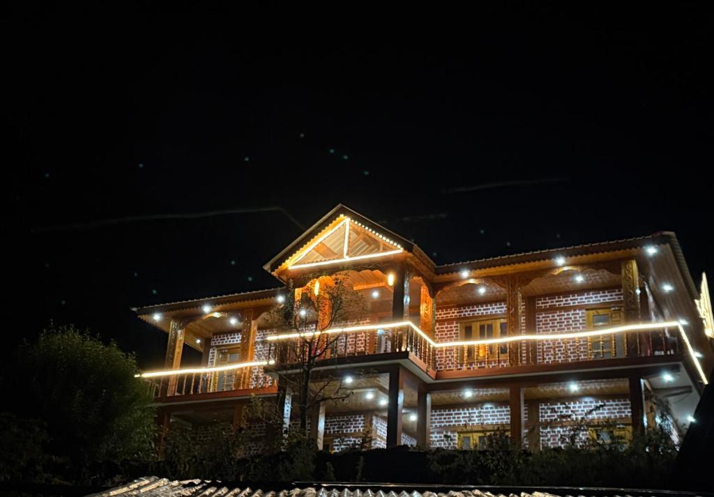 a house lit up at night with lights at Harshil View Home Stay in Harsil