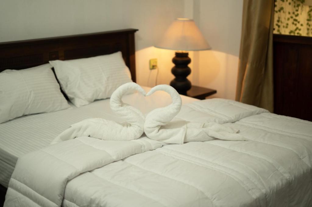 two swans making a heart on a bed at Nature Park villa in Arambegama