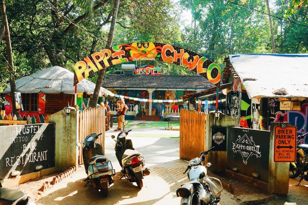 a group of motorcycles parked in front of a market at Pappi Chulo Vagator in Vagator