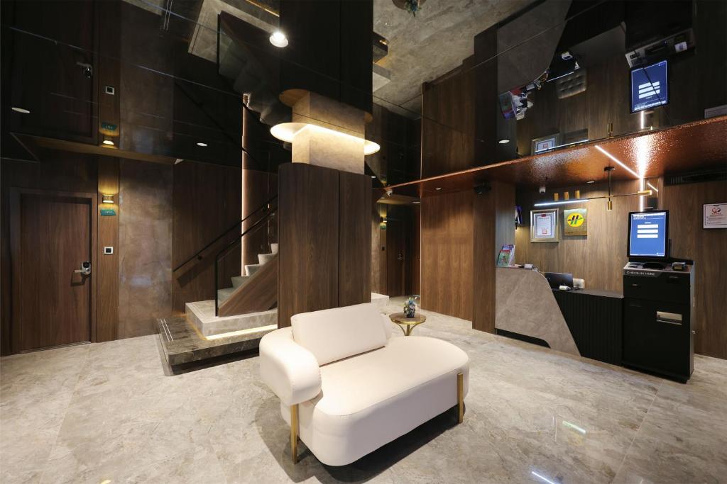 a white chair in a room with a staircase at Fun Stay Inn Hanzhong in Taipei