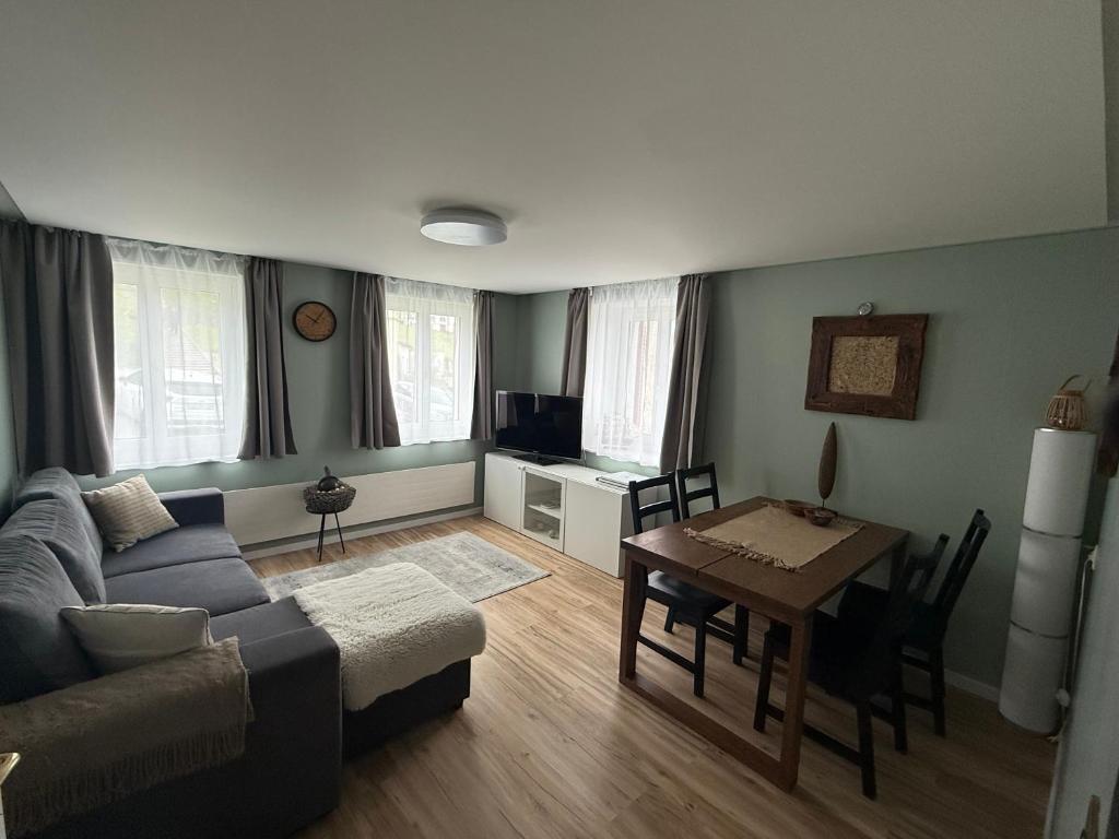 a living room with a couch and a table at Ferienwohnung Edelweiss in Wolfhalden 