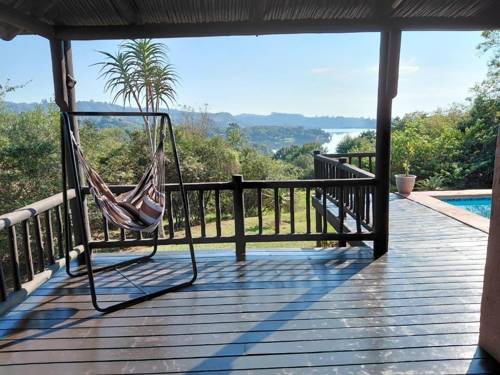 a hammock on a porch with a view of the water at Sickle Bush Da Gama Lake in White River
