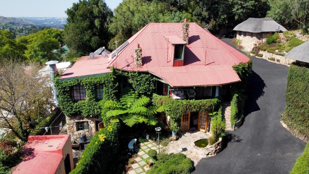 an overhead view of a house with a red roof at Gender Links Cottages in Johannesburg