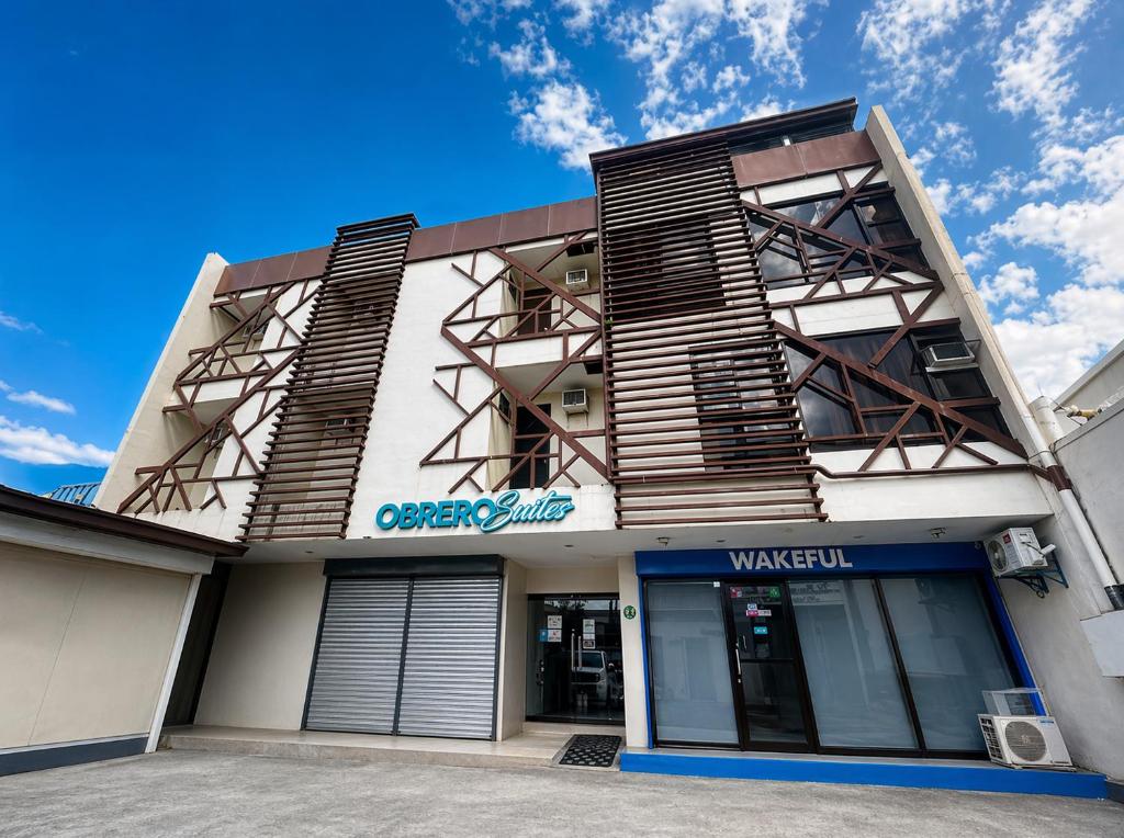a building with wooden shutters on it at Obrero Suites Davao in Davao City