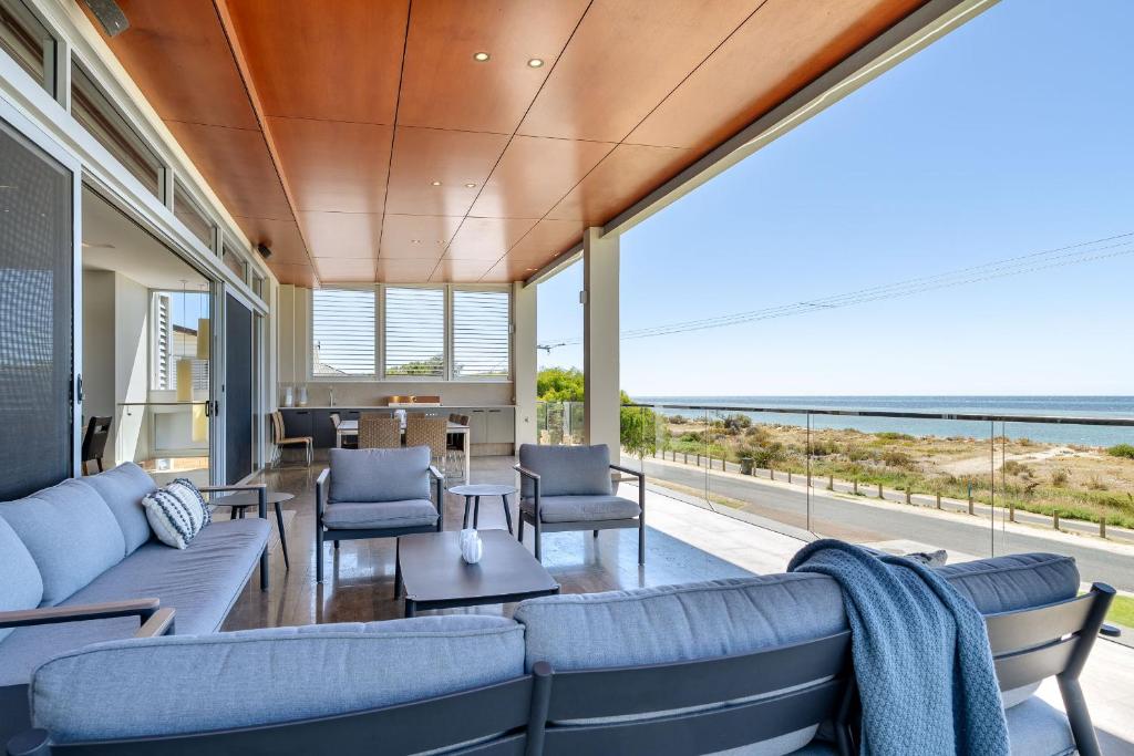 a living room with blue furniture and a view of the ocean at Number 10 I Private Properties in Dunsborough