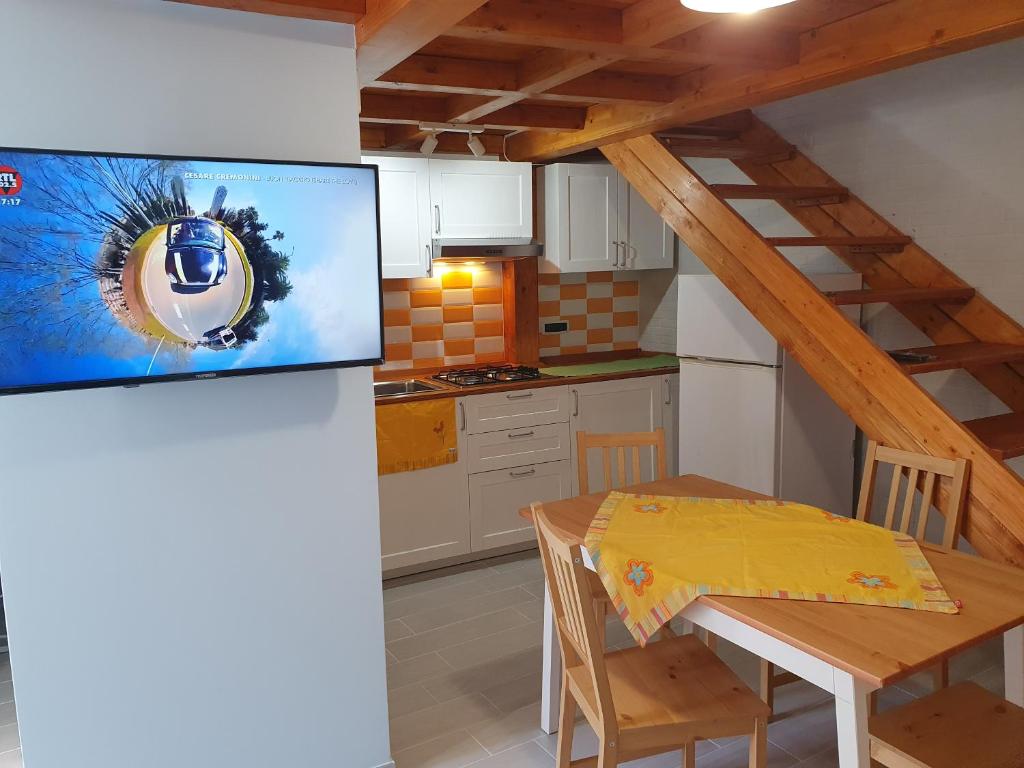a kitchen with a table and a dining room at Dimora Li Vinti in Cicciano