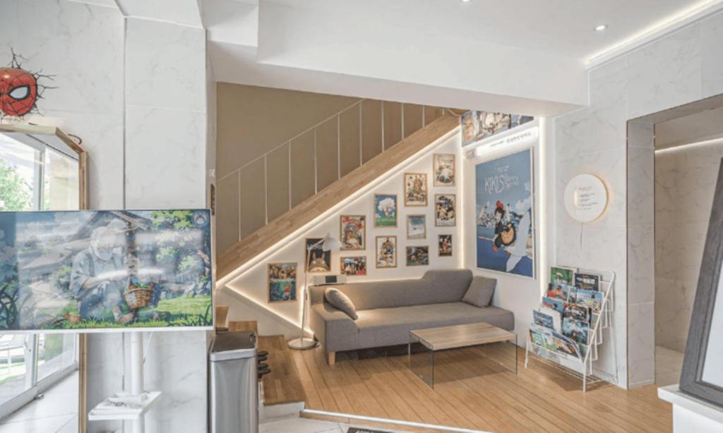 a living room with a couch and a staircase at Pohang Villa Dahlia in Pohang