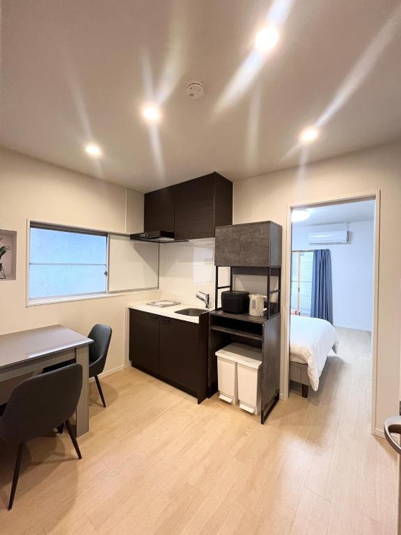 a kitchen with a sink and a bed in a room at Hotel Suite1 Quiet Family Stay Near Tokyo in Warabi