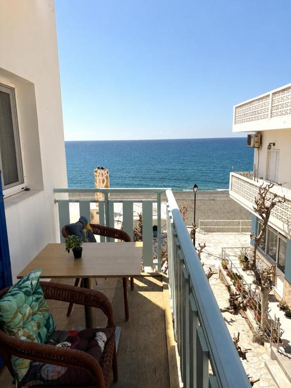 a balcony with a table and a view of the ocean at Maria Mare in Myrtos