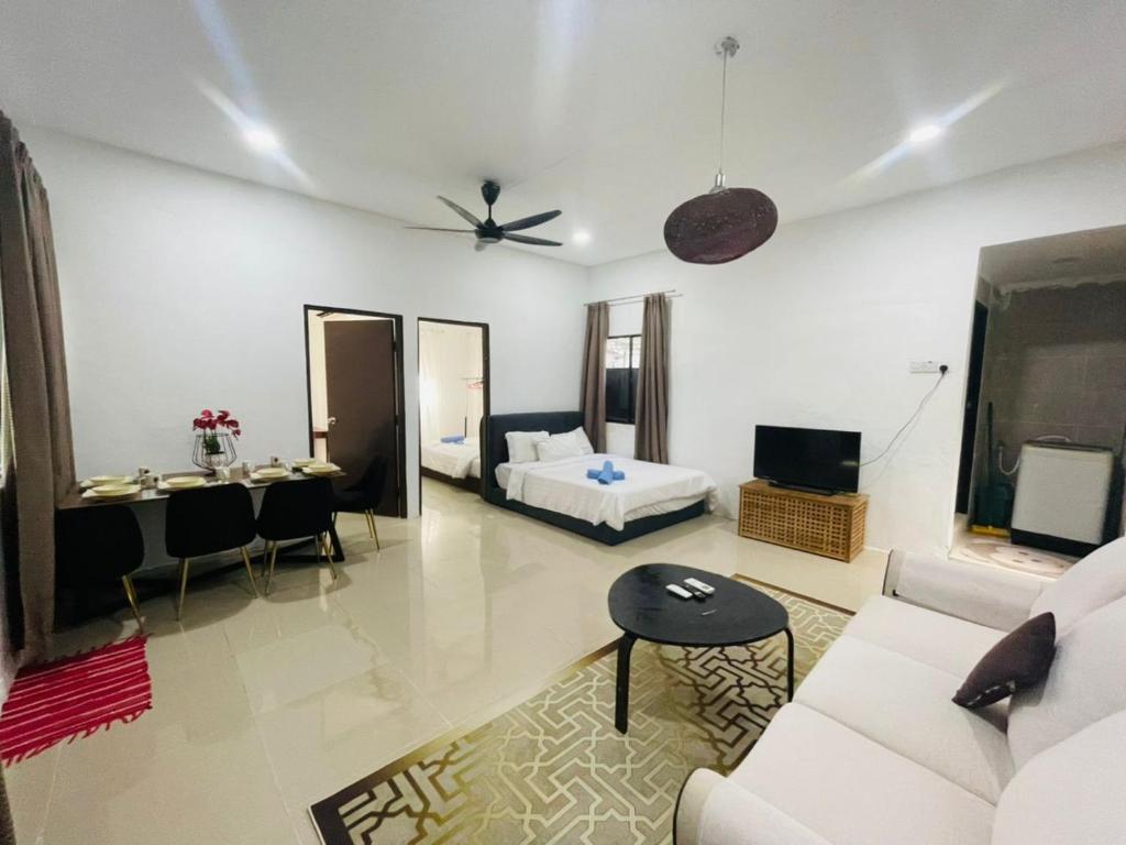 a living room with a couch and a bed at Ferringhi Beach Guesthouse-3bed in Batu Ferringhi