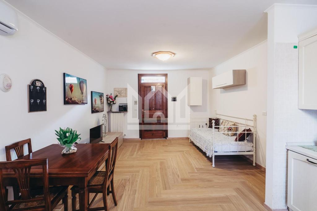 a dining room and living room with a table and a bed at Gold Palace ***** in Ferrara