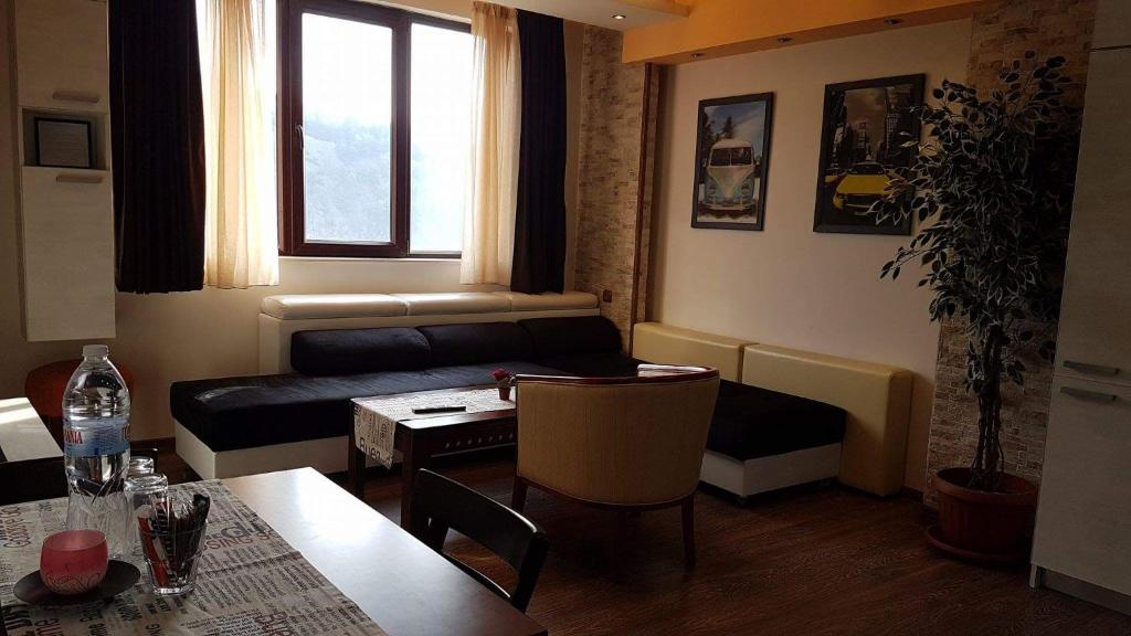 a living room with a couch and a table at Yana Apartments in Sandanski