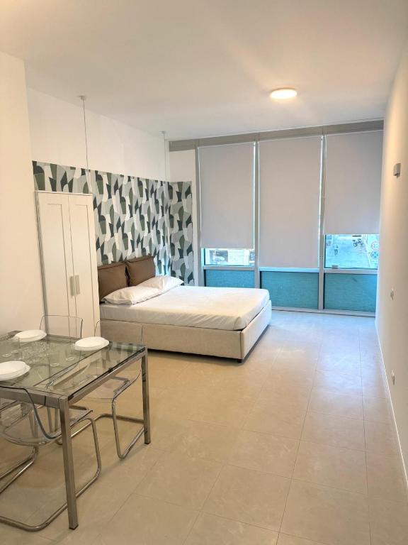 a bedroom with a bed and a table in it at Duca d Aosta apartment 3 in Monfalcone