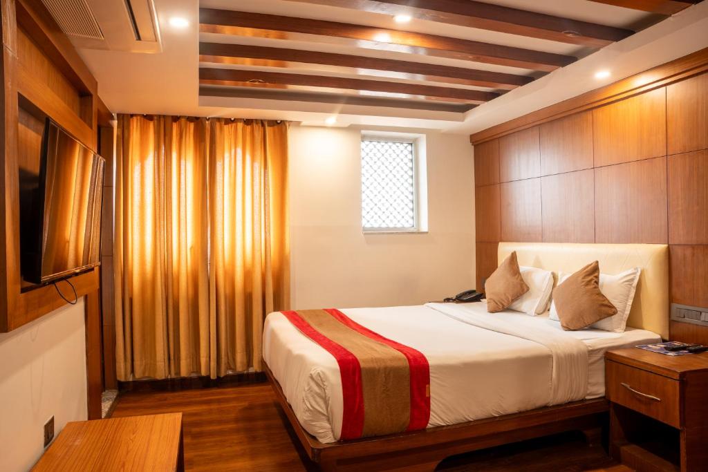 a bedroom with a large bed in a room at Hotel Kailash Kutee in Kathmandu