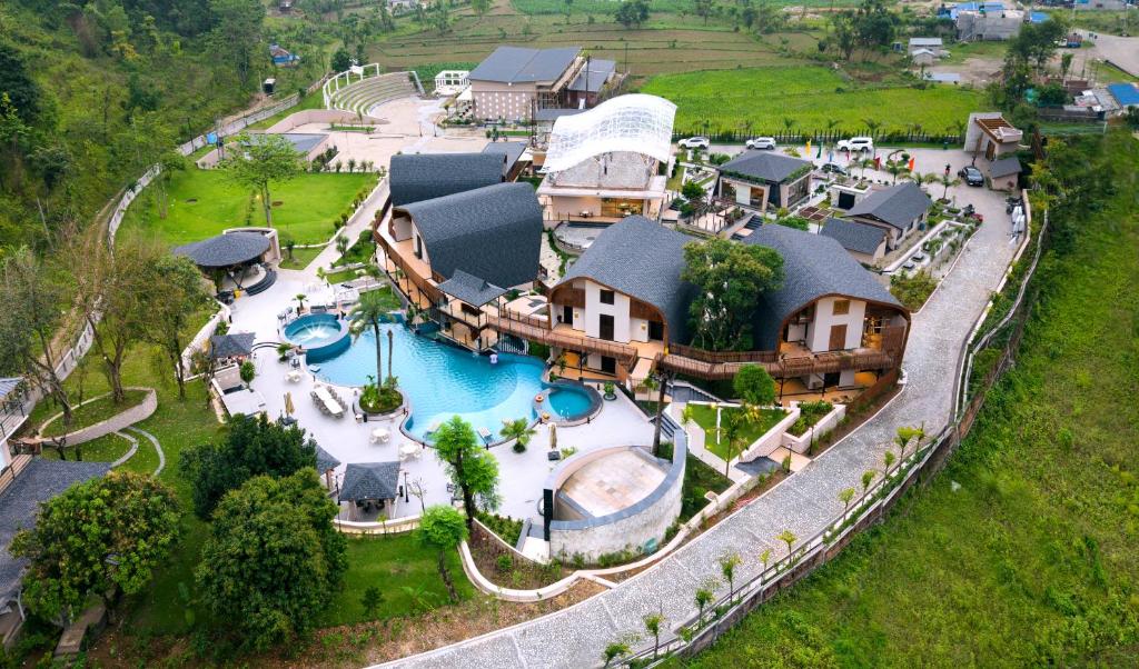 an aerial view of a house with a swimming pool at Latauli Sanctuary in Upardāng Garhi