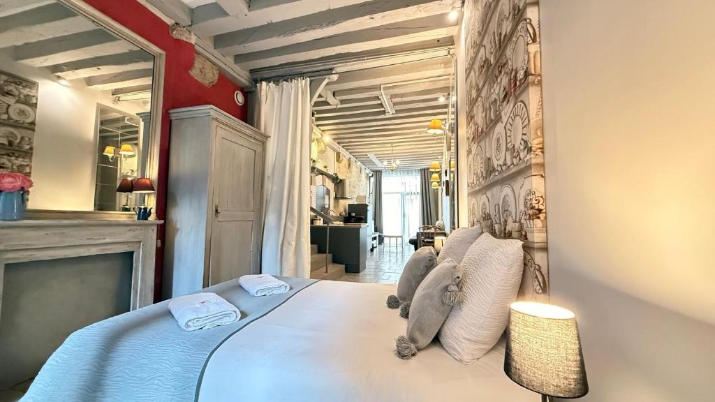 a bedroom with a bed with blue sheets and pillows at Le Nid de la Loire - Centre historique - 4 pers - Classé 3 étoiles in Blois