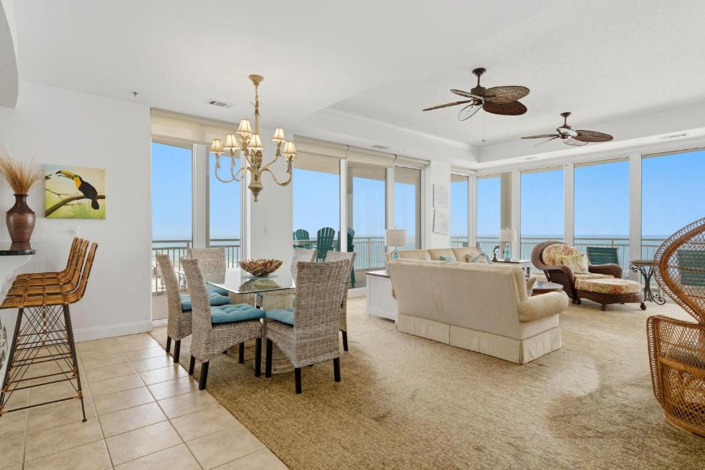 a living room with a couch and a table and chairs at La Playa 801 in Perdido Key