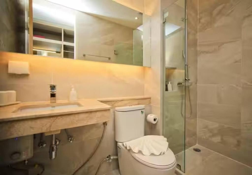 a bathroom with a toilet and a sink and a shower at Breezy Condo in Aonang in Ao Nang Beach