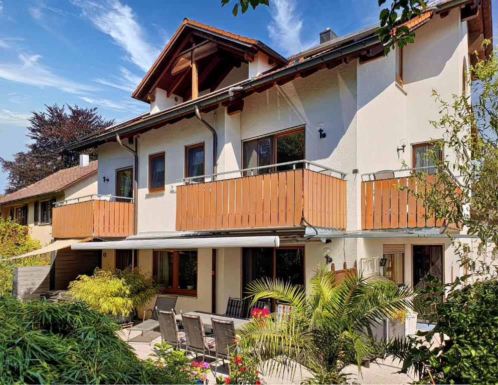 a large white house with a balcony at Seehaus Aachblick, Stilvolle Apartments und Ferienwohnungen in Uhldingen-Mühlhofen